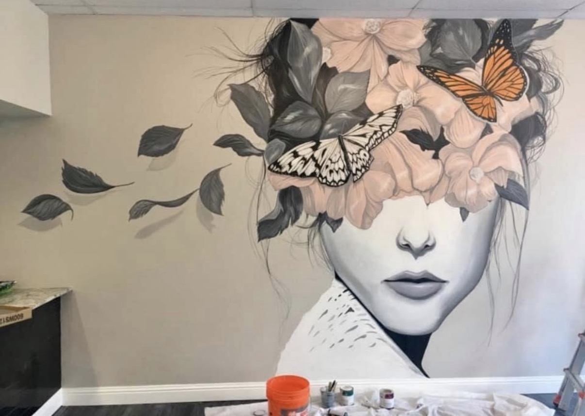 Floral portrait and butterfly mural in a creative studio