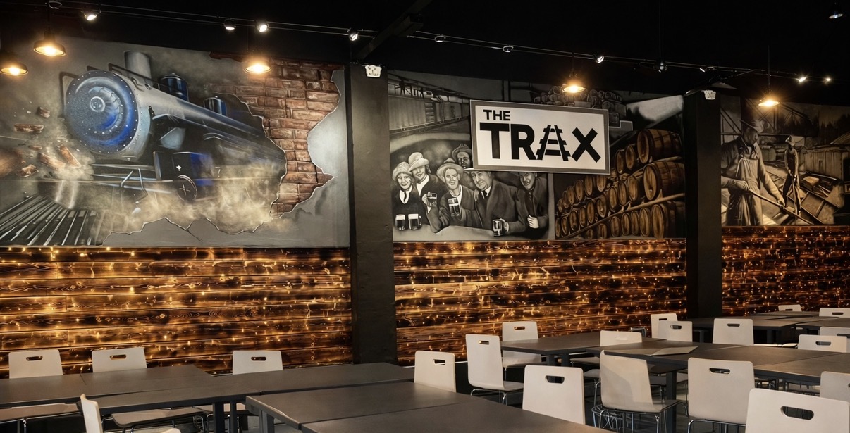 Panoramic railroad and industrial history mural inside TRAX